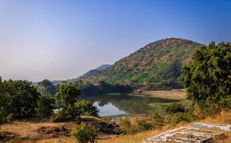 Pariyon ka Talab (Lake of the Fairies) near Khuldabad, with surrounding hills and greenery, once a sacred site of Hindu temples before being rebranded with new legends.