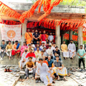 Group photo of Ramdoot Restores volunteers and members at a temple, dressed in traditional attire, after completing a restoration and cleaning effort.