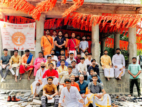 Group photo of Ramdoot Restores volunteers and members at a temple, dressed in traditional attire, after completing a restoration and cleaning effort.