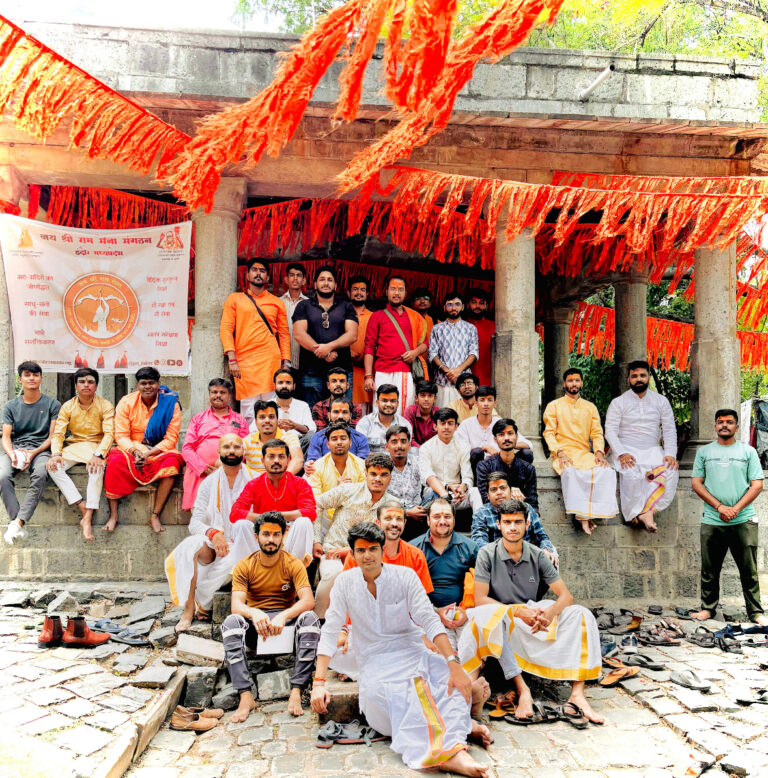 Group photo of Ramdoot Restores volunteers and members at a temple, dressed in traditional attire, after completing a restoration and cleaning effort.