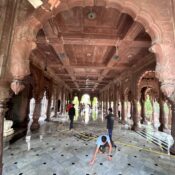 Ramdoot Restores volunteers cleaning the marble floor of a historic temple hall as part of a restoration drive.